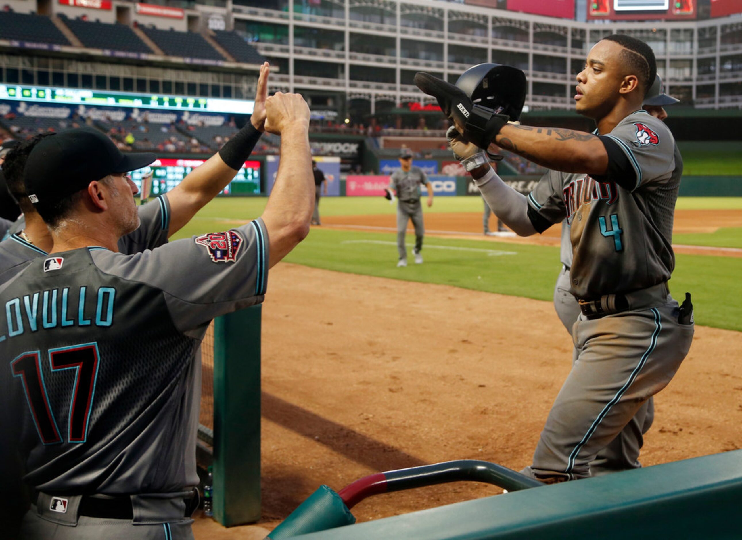 Arizona Diamondbacks manager Torey Lovullo (17), left, congratulates Ketel Marte (4), right,...