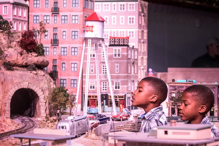 Seven-year-old twins Mervin and Mason Jobe of Fort Worth check out the train exhibit during...