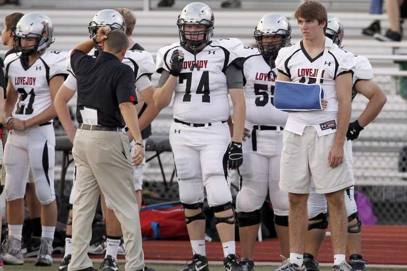 An injured Lovejoy Leopards QB Bowman Sells (15) watches from the sideline in the first half...