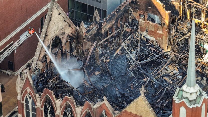 Dallas firefighters focused on hot spots at the gutted old sanctuary of First Baptist Dallas...