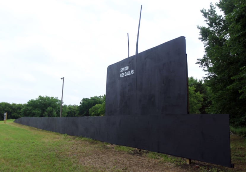 A huge plywood cutout of the USS Dallas attack submarine is sitting at a Riverfront...