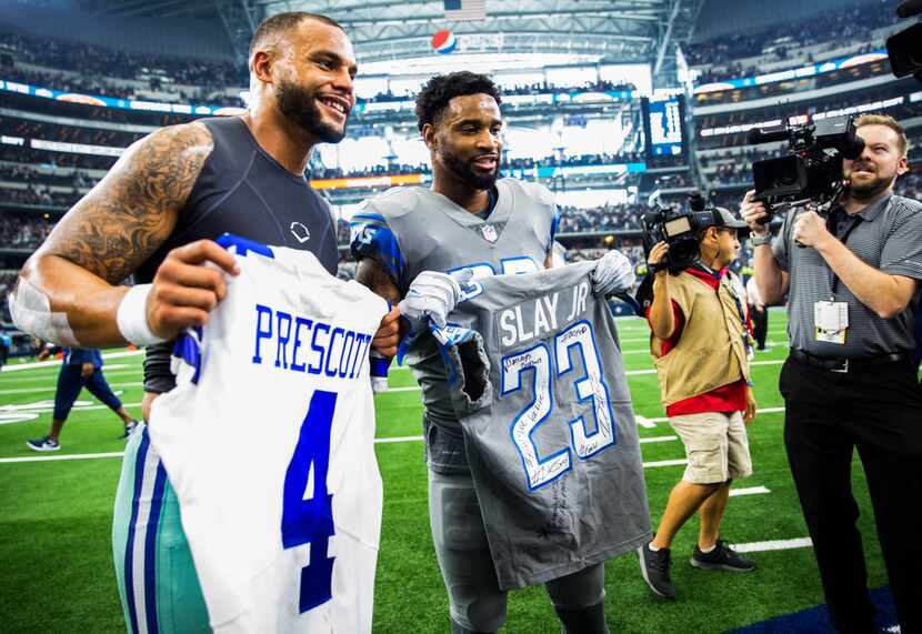 Dallas Cowboys quarterback Dak Prescott (4) poses for a photo with Detroit Lions defensive...