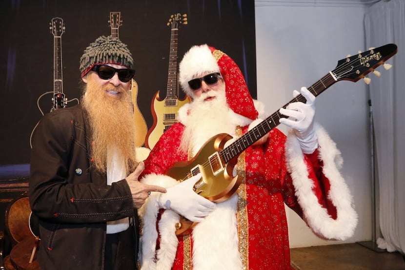 Texas music legend Billy Gibbons and Santa Claus pose for photographs during the unveiling...