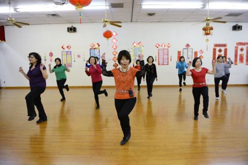 
Instructor Juliet Lam (center) leads Asian woman in a line dancing class on Feb. 11 at the...