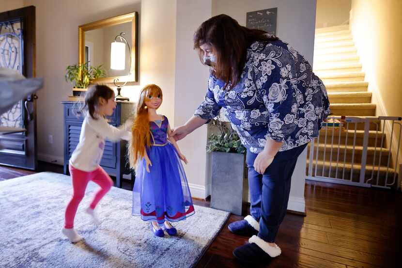 Carmen Lozoya (right) of Fort Worth plays with granddaughter Esme Bueno Galindo and an Anna...