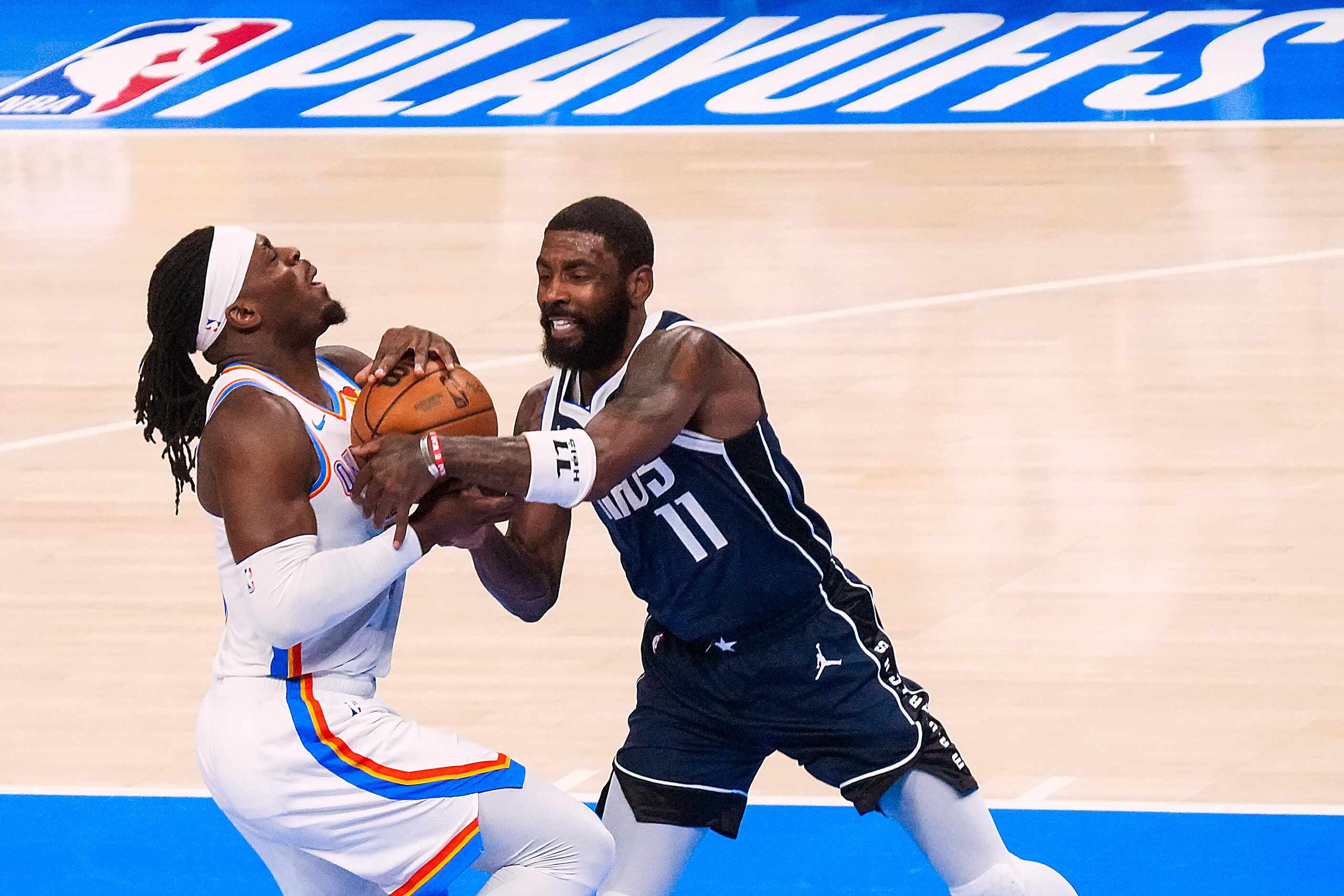 Oklahoma City Thunder guard Luguentz Dort (5) drives to the basket as Dallas Mavericks guard...