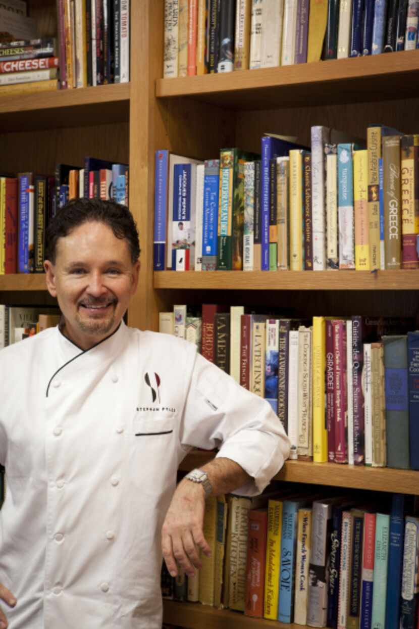 Chef Stephan Pyles with his in-home cookbook collection