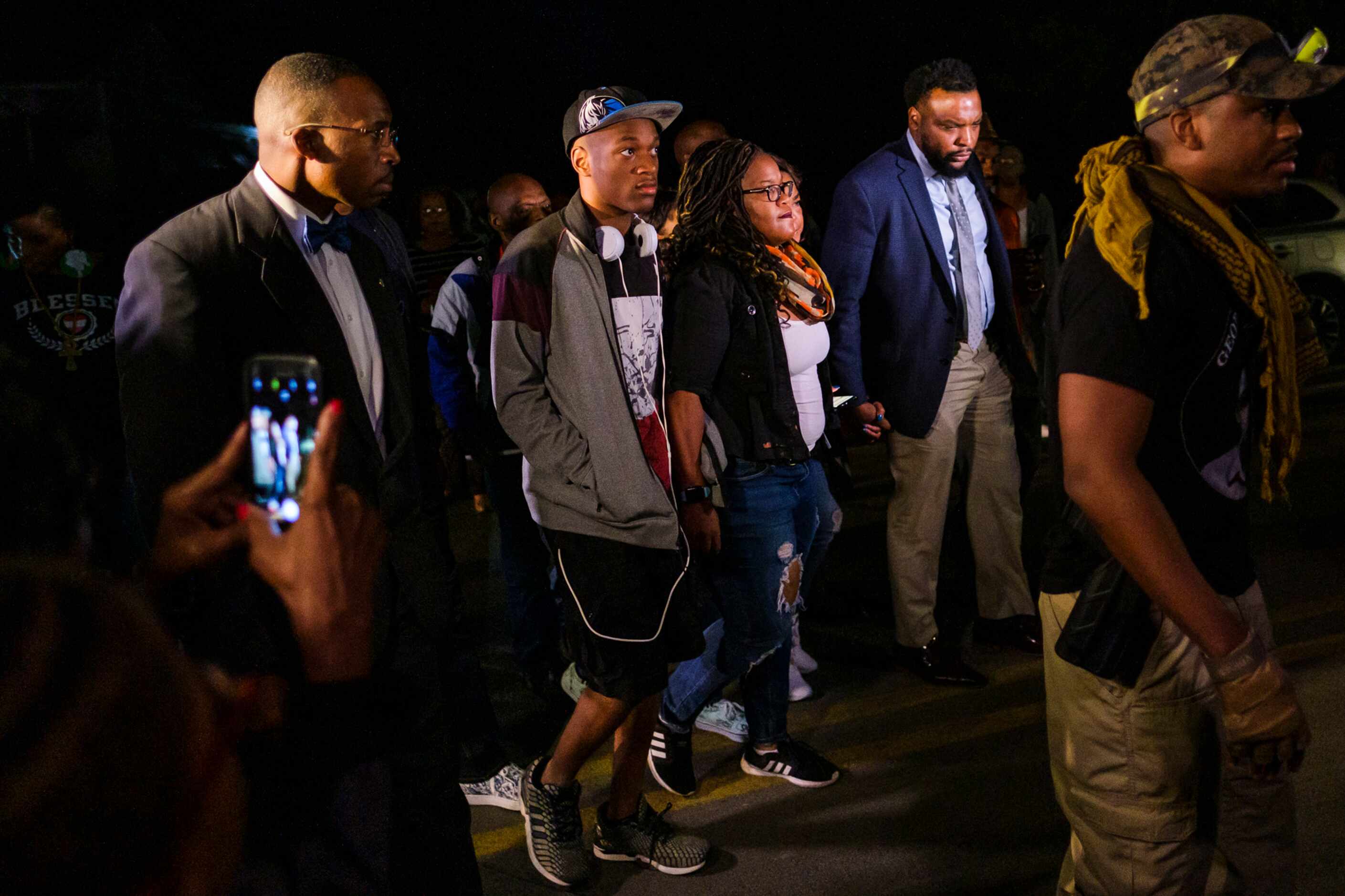 Attorney Lee Merritt (right) walks with members of the victimÕs family as they arrive at...