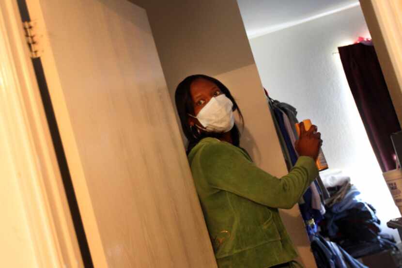 Lavetra Goss donned a mask and sprayed disinfectant before entering the bedroom where her...