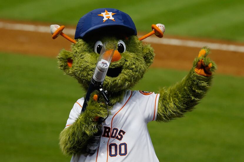 Houston Astros mascot Orbit prepares to fire a shirt into the crowd during a game against...