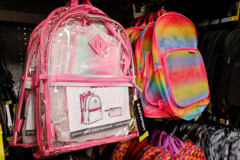 Clear and mesh backpacks priced at $11.89 each filledpart of an aisle of school supplies at...