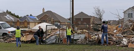  Volunteers help tornado victims remove debris in Garland, Texas, Friday, Jan. 1, 2016. (Jae...