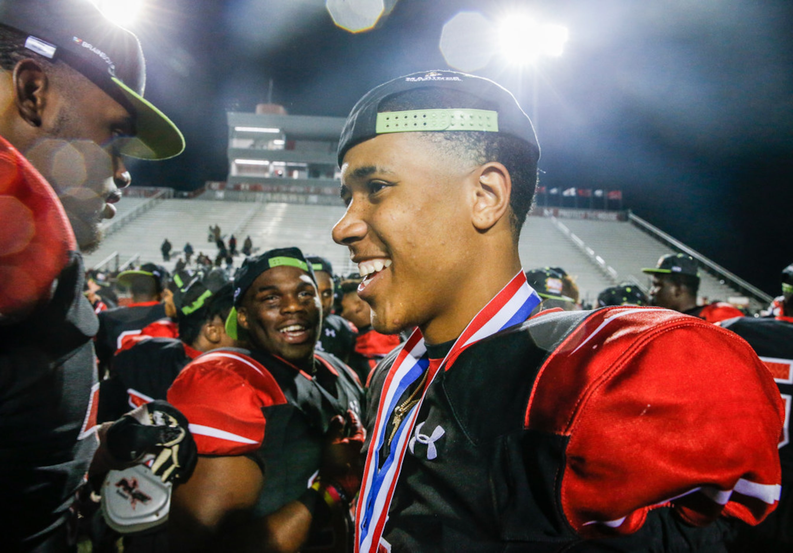 The Cedar Hill Longhorns celebrate their 7-6A district championship win over the DeSoto...