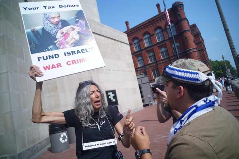 
A woman demonstrating against Israeli action in Gaza and a supporter of Israel argued...