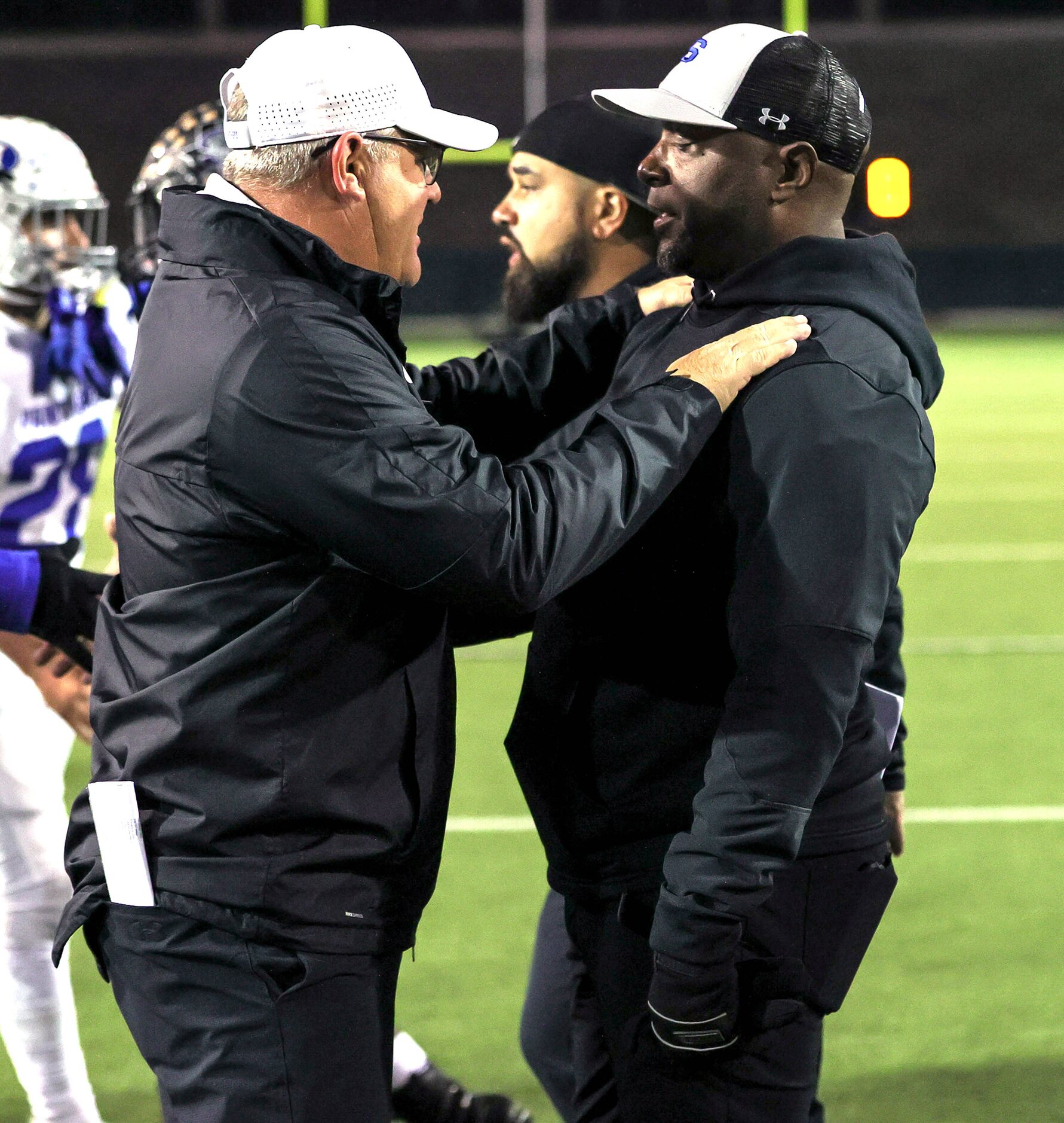 Midlothian head coach Doug Wendel (L) greets Mansfield Summit head coach Channon Hall (R)...