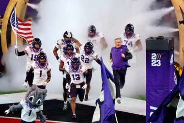 TCU Horned Frogs head coach Sonny Dykes (right) and his players take the field to face the...