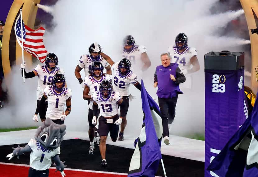 TCU Horned Frogs head coach Sonny Dykes (right) and his players take the field to face the...