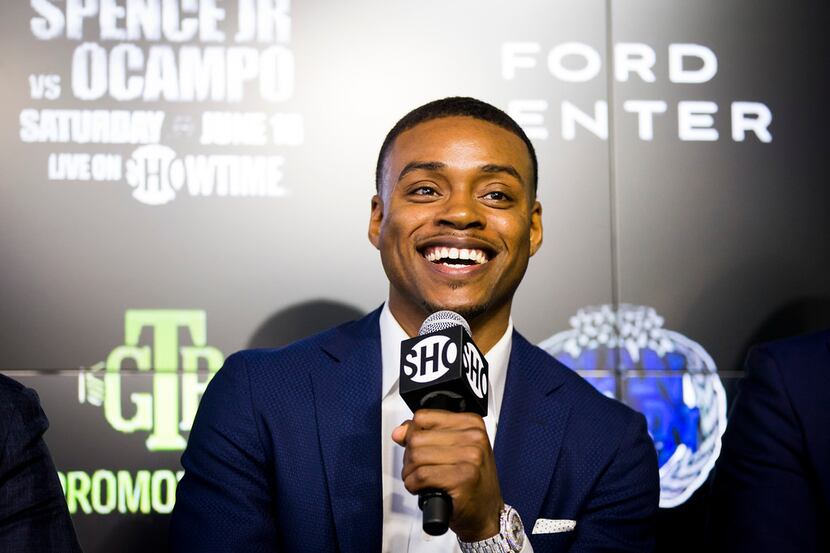 Boxer Errol Spence Jr.  laughs during a press conference to promote his welterweight title...