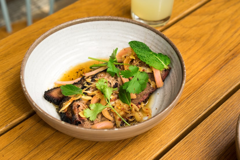 Loro serves smoked beef brisket with chile gastrique and Thai herbs. 