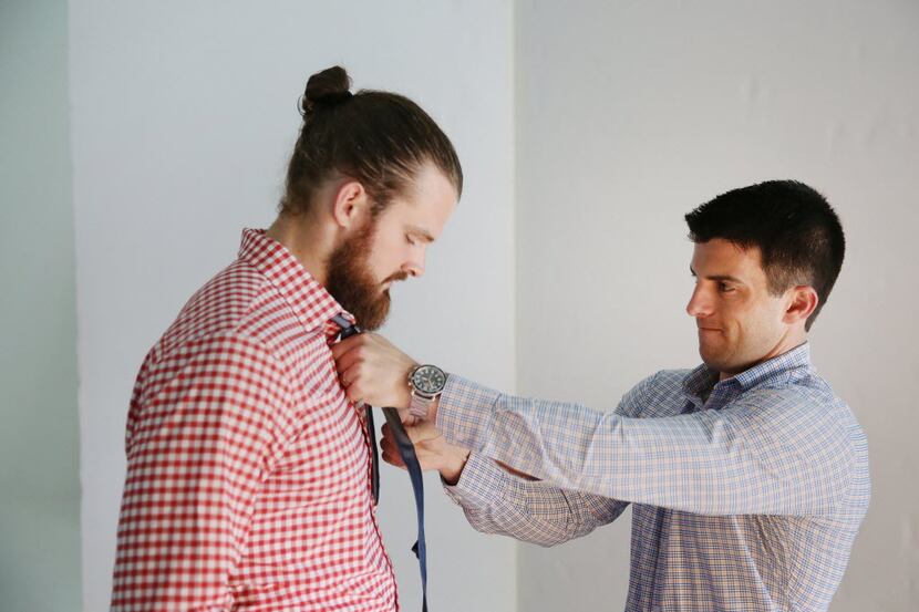 Kevin Lavelle, founder and CEO of Mizzen+Main, places a tie on New Orleans Saints punter...