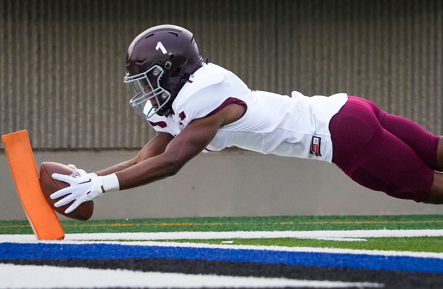 Mansfield Timberview running back Jarvis Reed dives for the pylon to score on a touchdown...