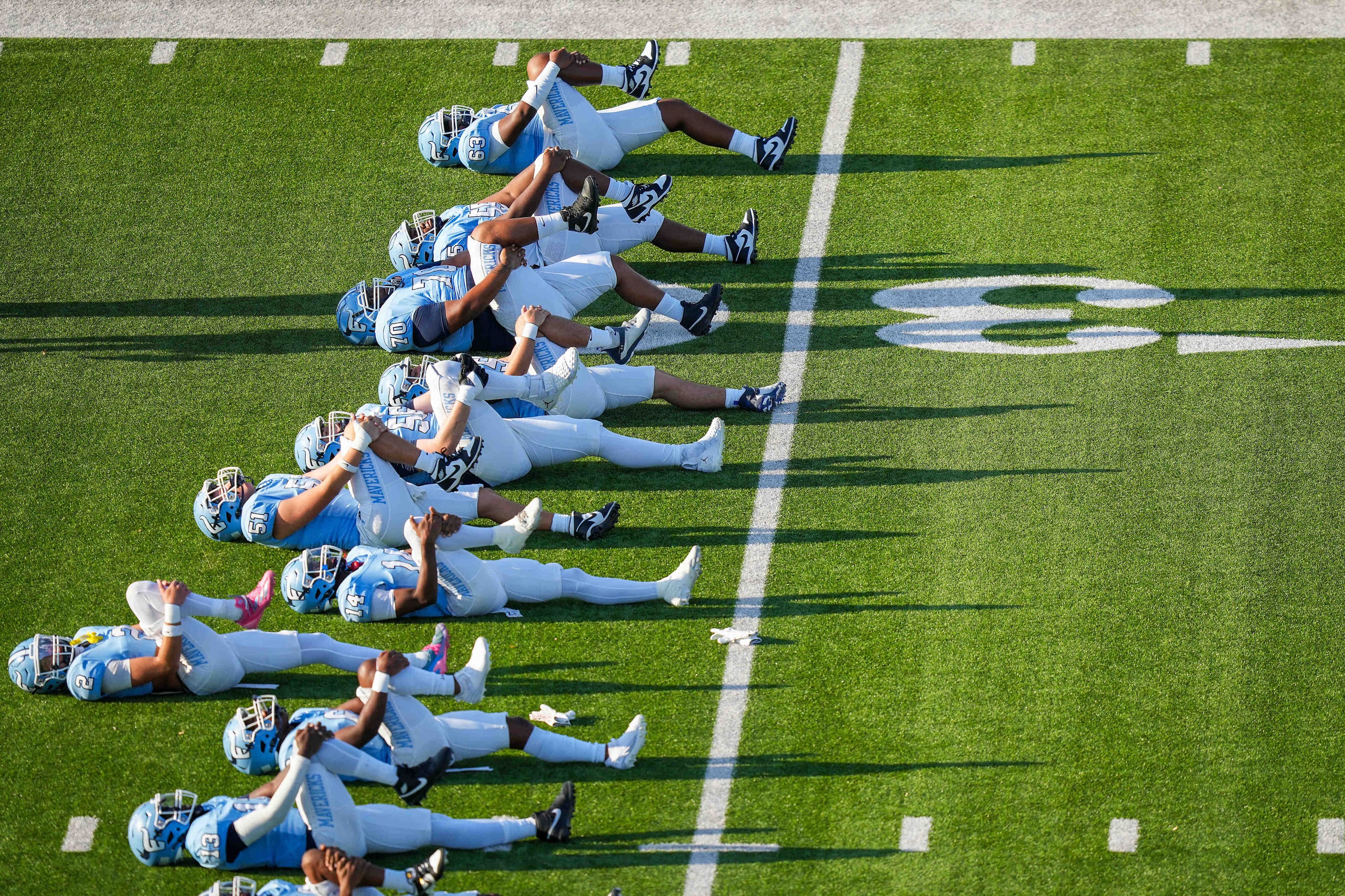 Frisco Emerson players warm up before a District 4-5A Division II high school football game...