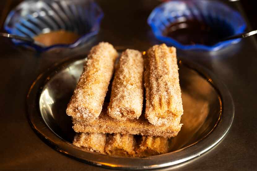 Churros served on a mini paleta style cart with sweet dipping sauces from El Patio restaurant