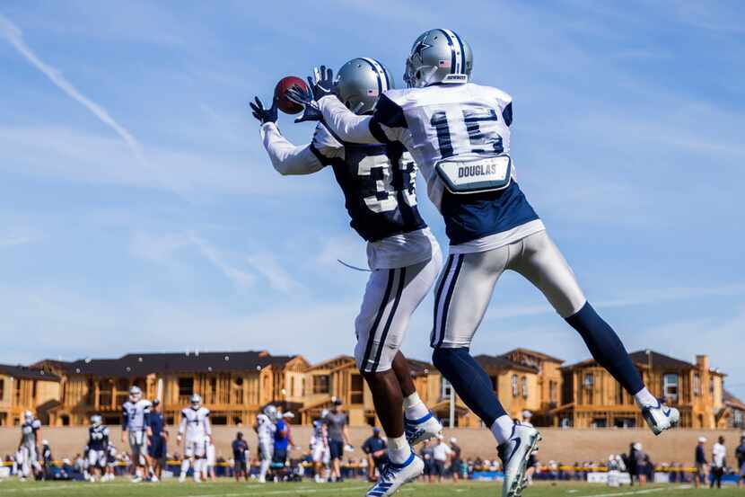 Dallas Cowboys cornerback Michael Jackson (33) intercepts a pass intended for wide receiver...