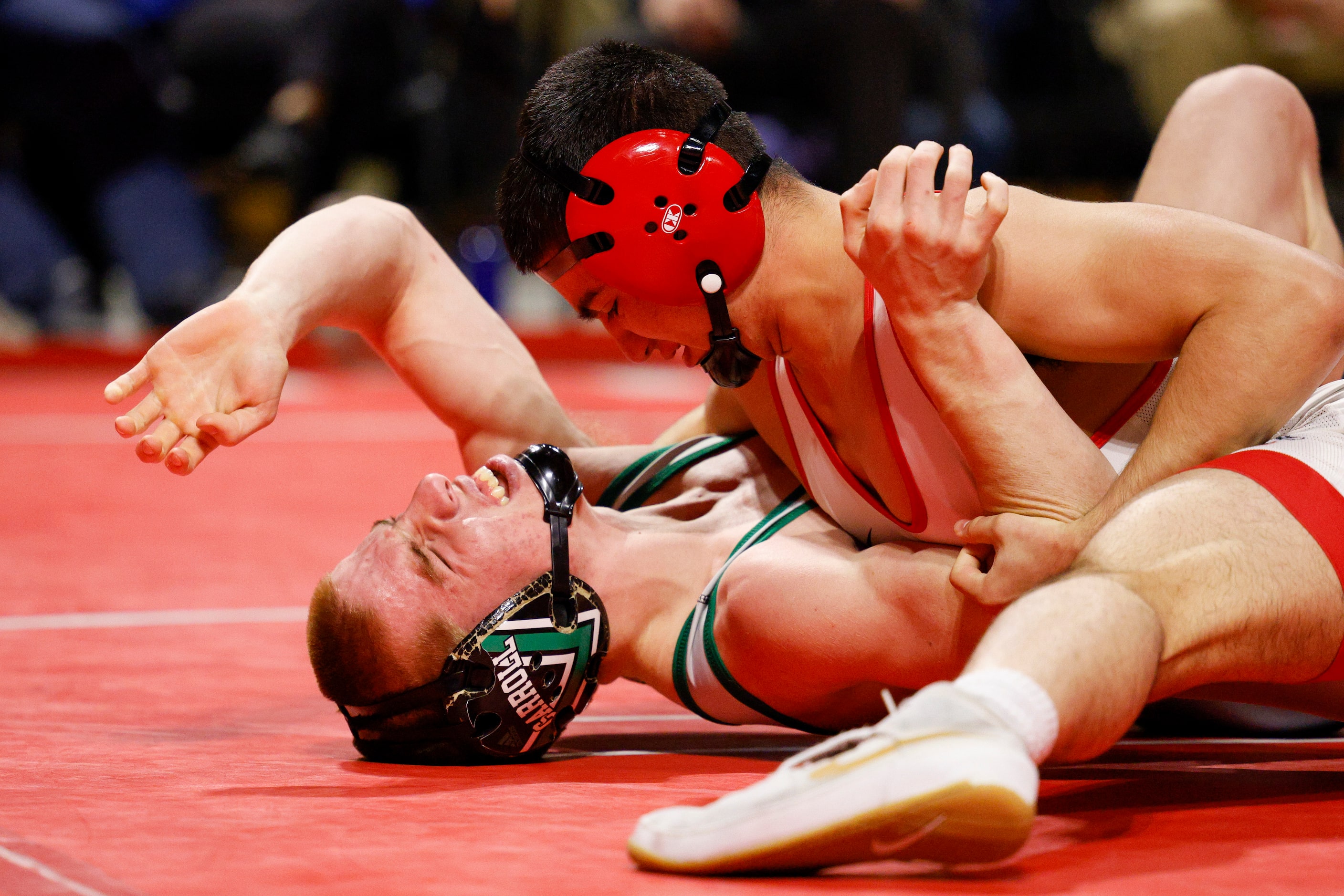 Cole Bennett of Southlake Carroll (left) wrestles Kade Moore of Allen during the...