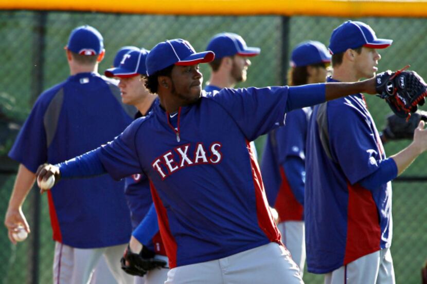 Texas Rangers pitcher Neftali Feliz throws during spring training camp Wednesday, February...