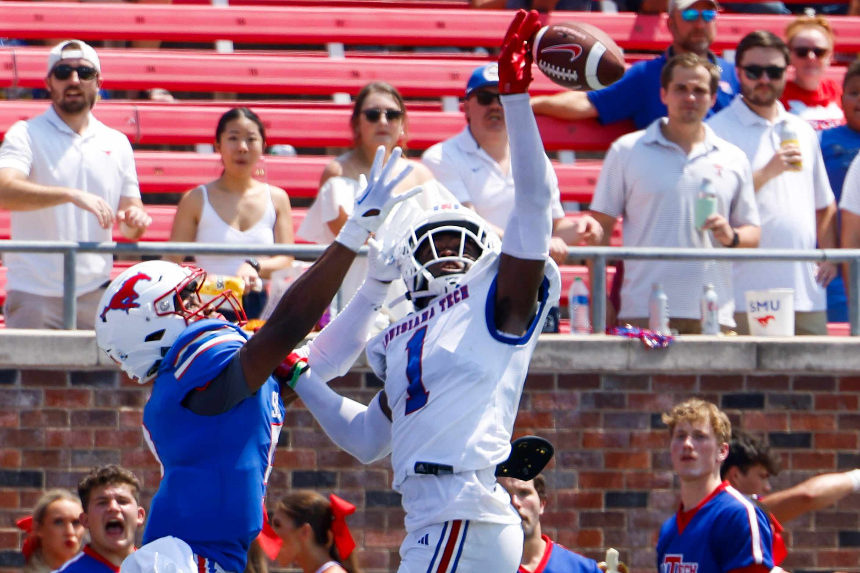 Southern Methodist wide receiver Moochie Dixon (left) reaches to receive a touchdown pass as...