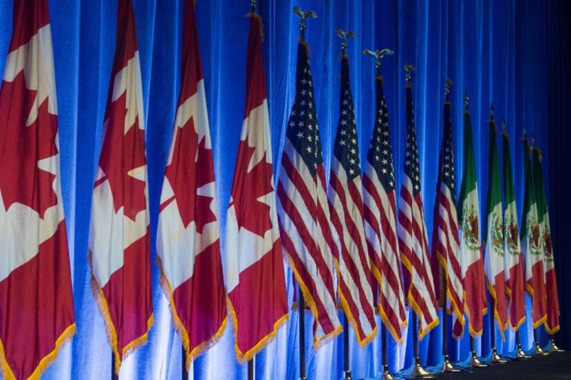 The flags of Canada, the United States, and Mexico lined the stage before the start of the...