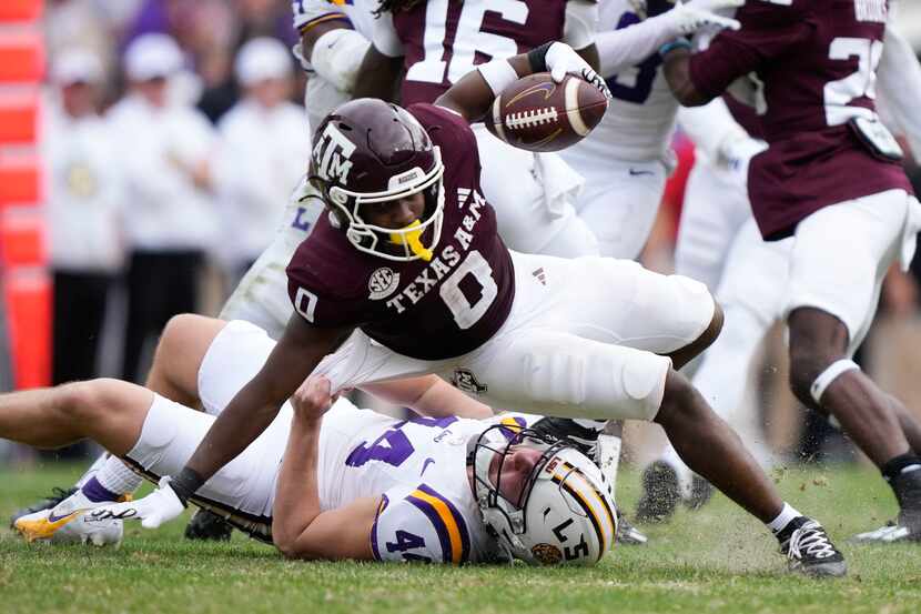 Texas A&M wide receiver Ainias Smith (0) is tackled by LSU linebacker Christian Brathwaite...
