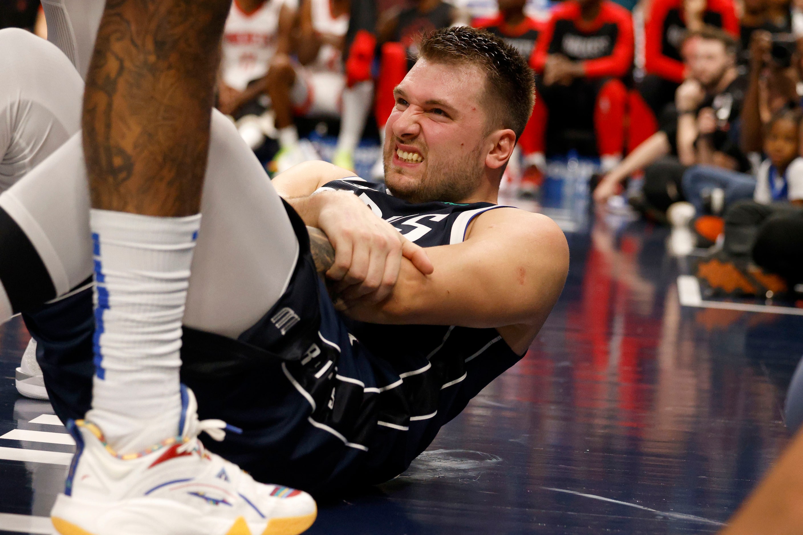 Dallas Mavericks guard Luka Doncic (77) reacts after falling down on the floor during the...