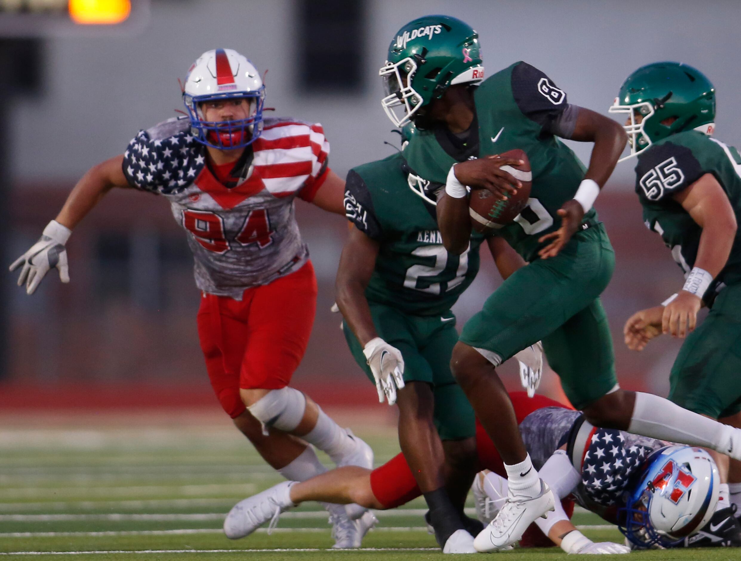 Kennedale quarterback Paul Donkor (8), right, rolls out of the backfield on a quarterback...