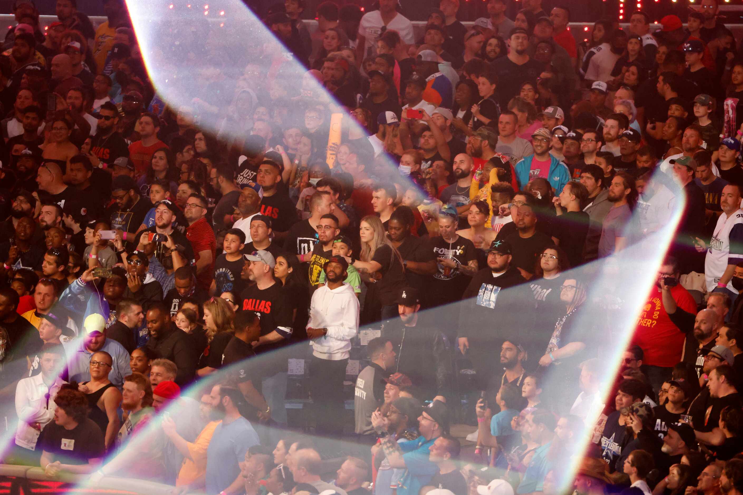 Fans cheer during a light show at WrestleMania in Arlington, Texas on Saturday, April 2, 2022. 