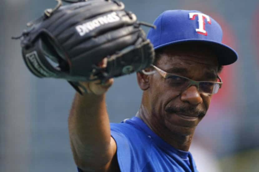 Rangers manager Ron Washington waves to the Detroit dugout as he walks off the field after...