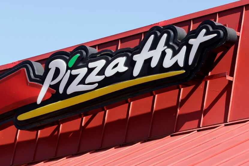 This Tuesday, Jan. 24, 2017, photo shows a Pizza Hut sign at a restaurant in Miami. Yum...