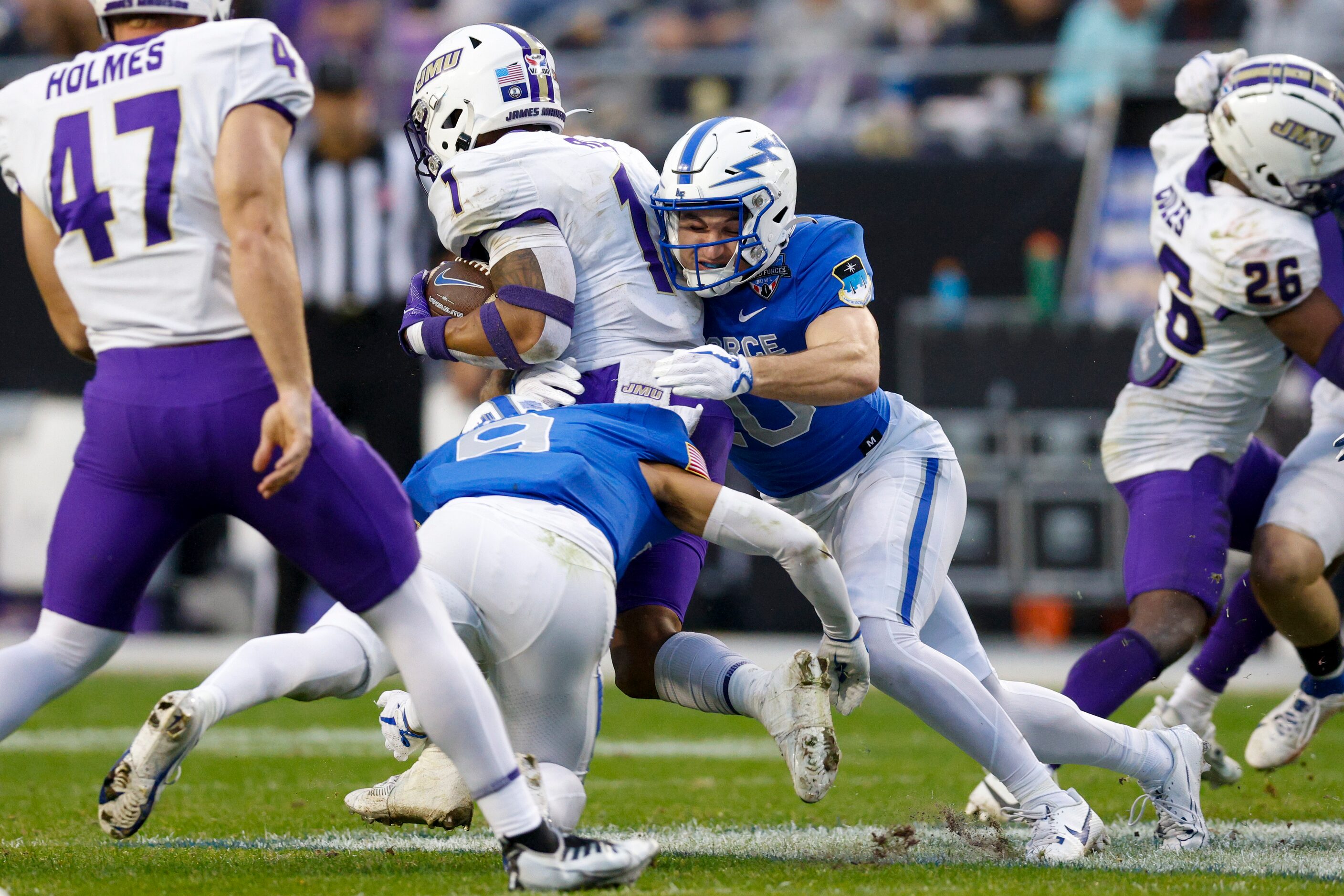 Air Force Falcons safety Jake Smith (20) tackles James Madison Dukes wide receiver Reggie...