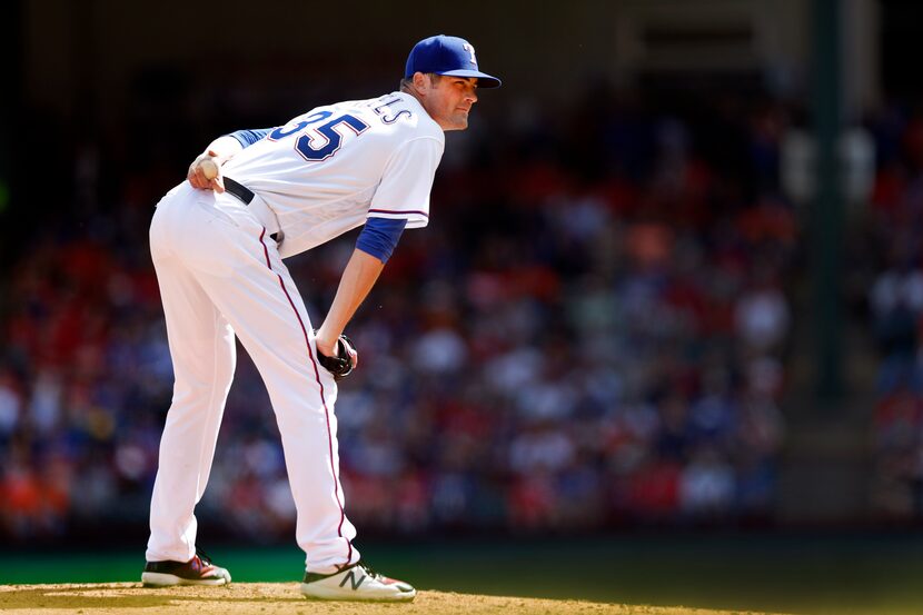 Texas Rangers starting pitcher Cole Hamels (35) looks for a sign from the catcher before...