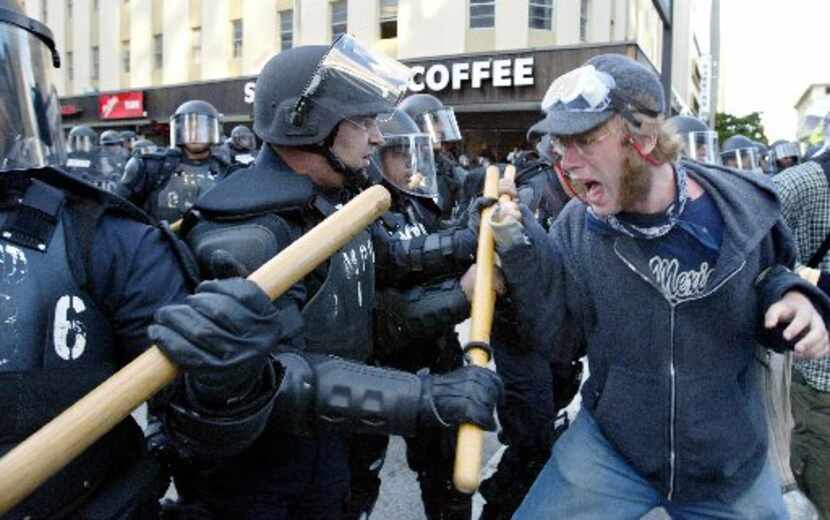 Anti globalization protesters clash with police in riot gear Nov. 20, 2003 on the fourth day...