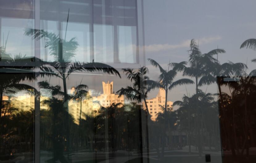 Art Deco buildings are reflected in the building's windows.