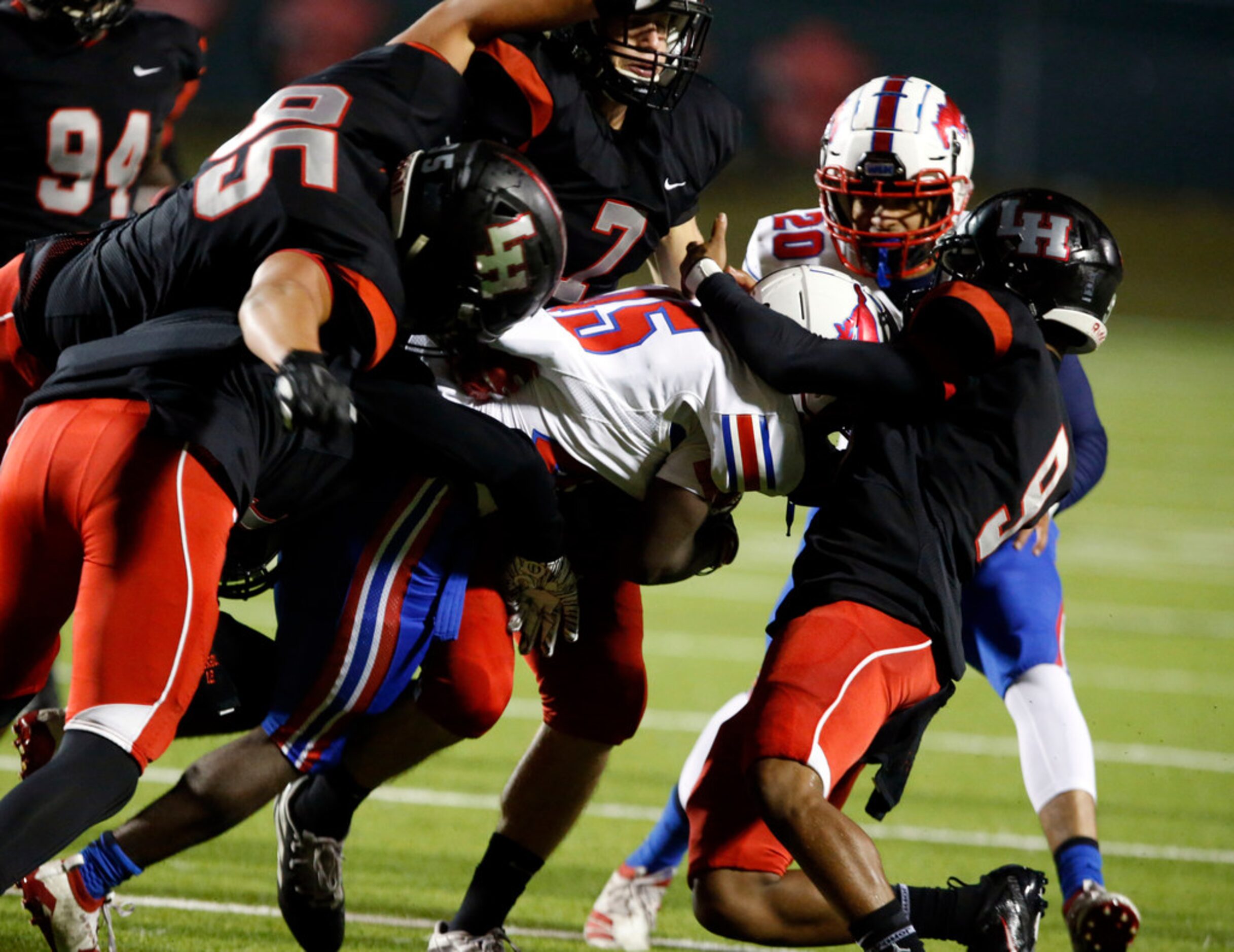 Richardson Pearce RB Dequan Landon (45) is buried under a pile of Lake Highlands defenders...