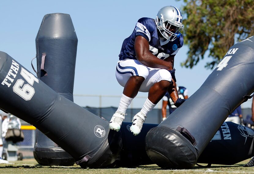 Dallas Cowboys offensive tackle Chaz Green (79) battles through the blocking dummies during...