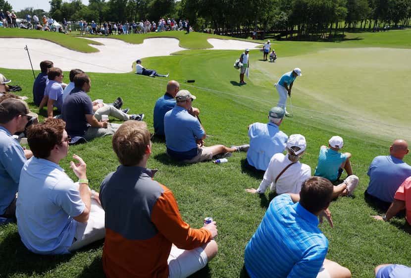 Fans watched as eventual winner K.H. Lee hit a putt on the 12th hole during Round 1 of the...