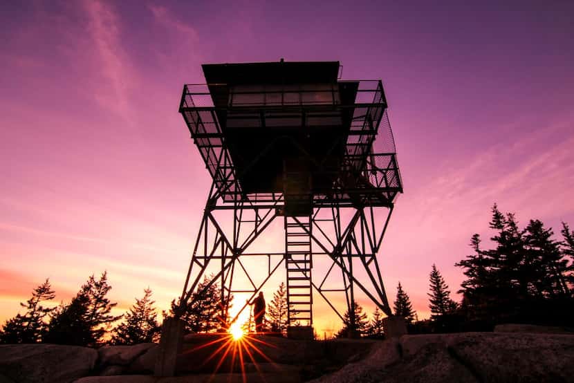 Sunlight peeks above the ground at the Beech Mountain Fire Lookout in Acadia National Park. 