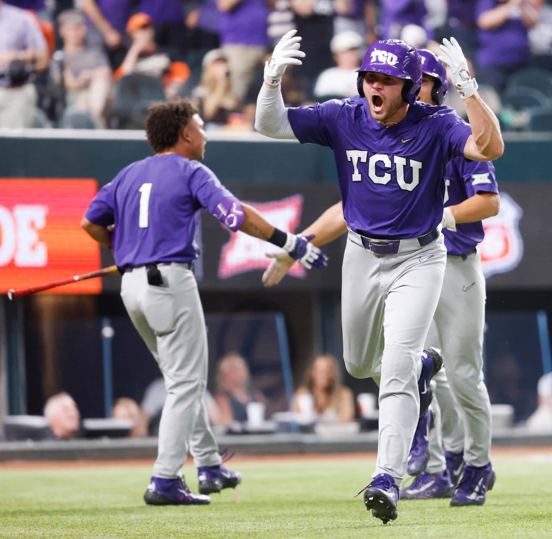 TCU outfielder Luke Boyers (front) cheers after a three run homer during the second inning...