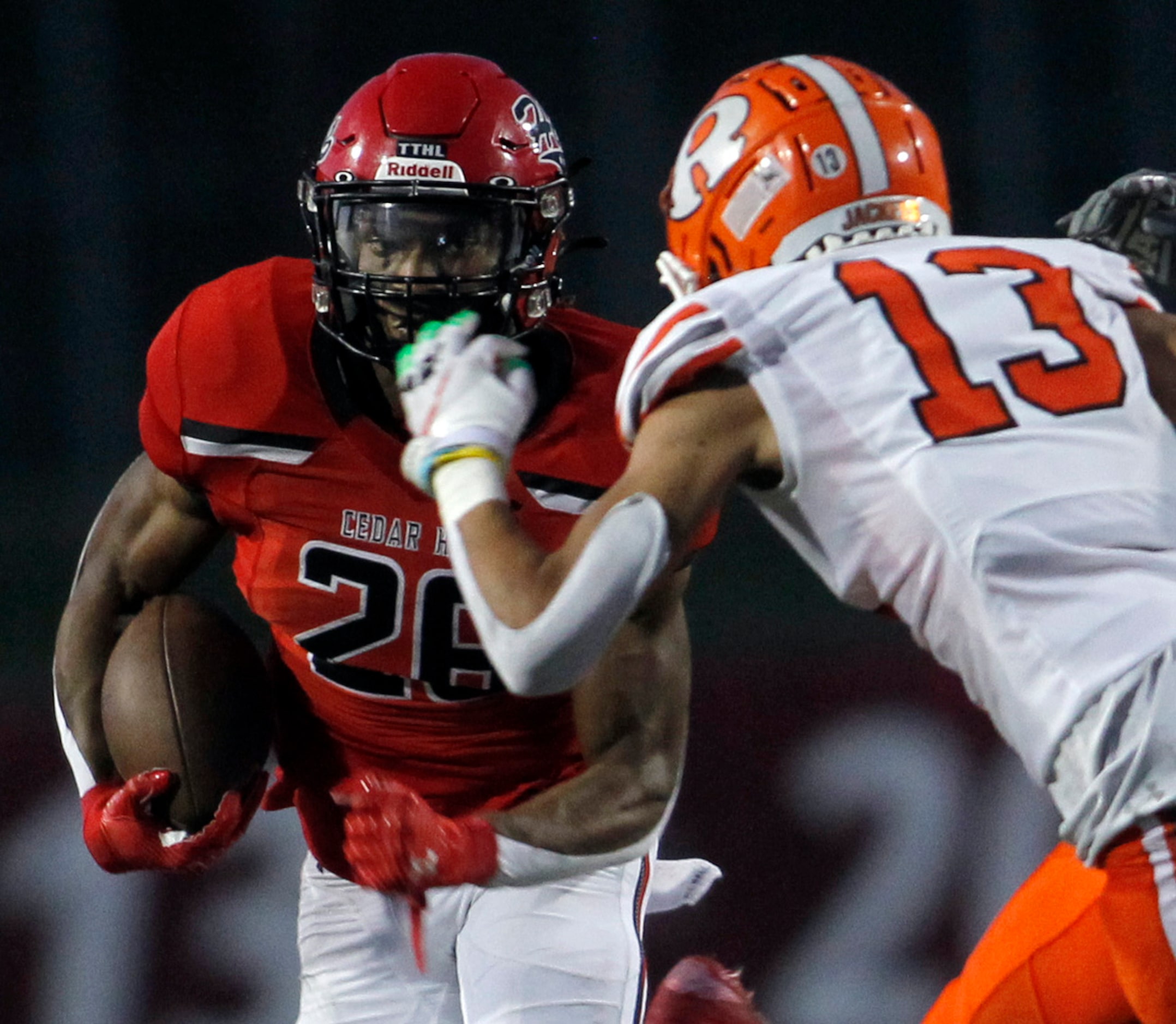 Cedar Hill running back Jaylen Jenkins (26), left, eyes the defense of Rockwall cornerback...