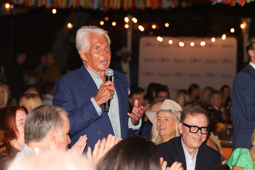 George Hamilton stands up in the audience to place himself on the auction block at the...