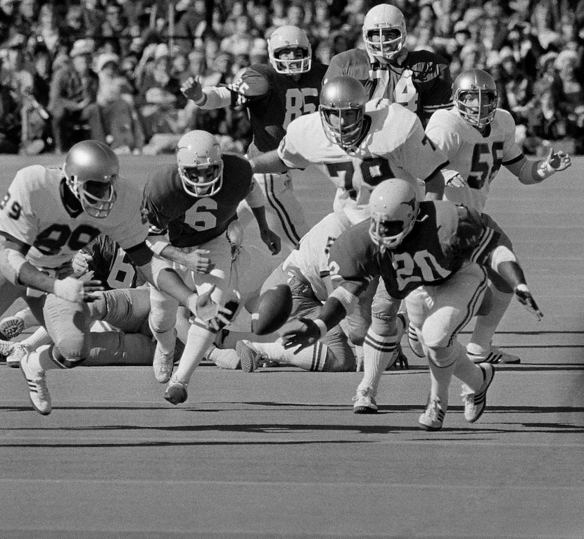 Randy McEachern, Texas quarterback, watches the ball get away from him in the first quarter...